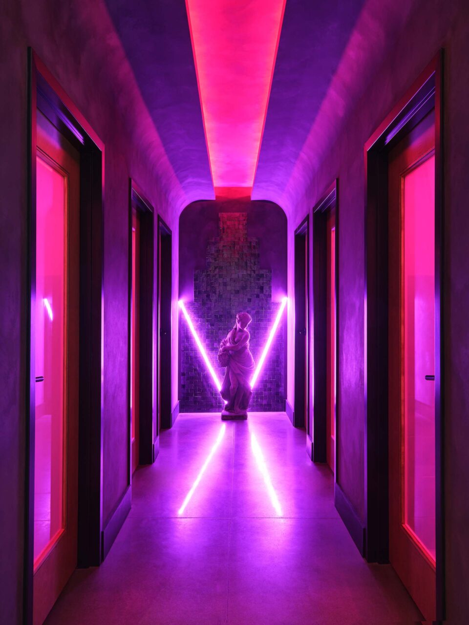 A glowing purple and pink bathroom at Madre