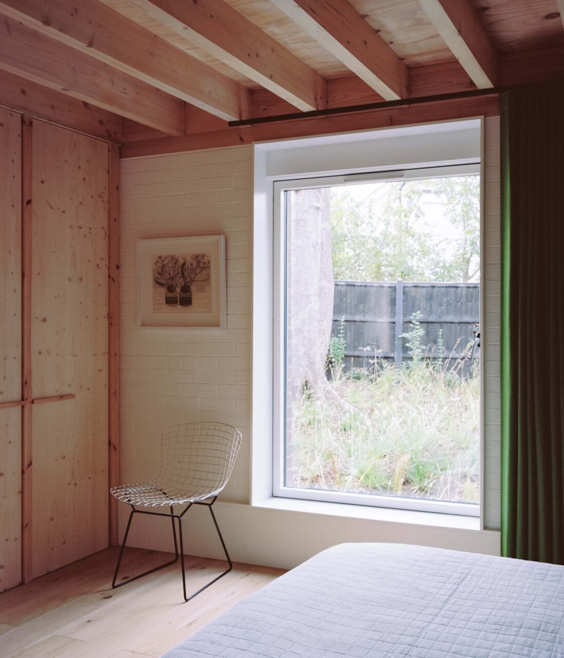 A bedroom at Six Columns has a green velvet curtain