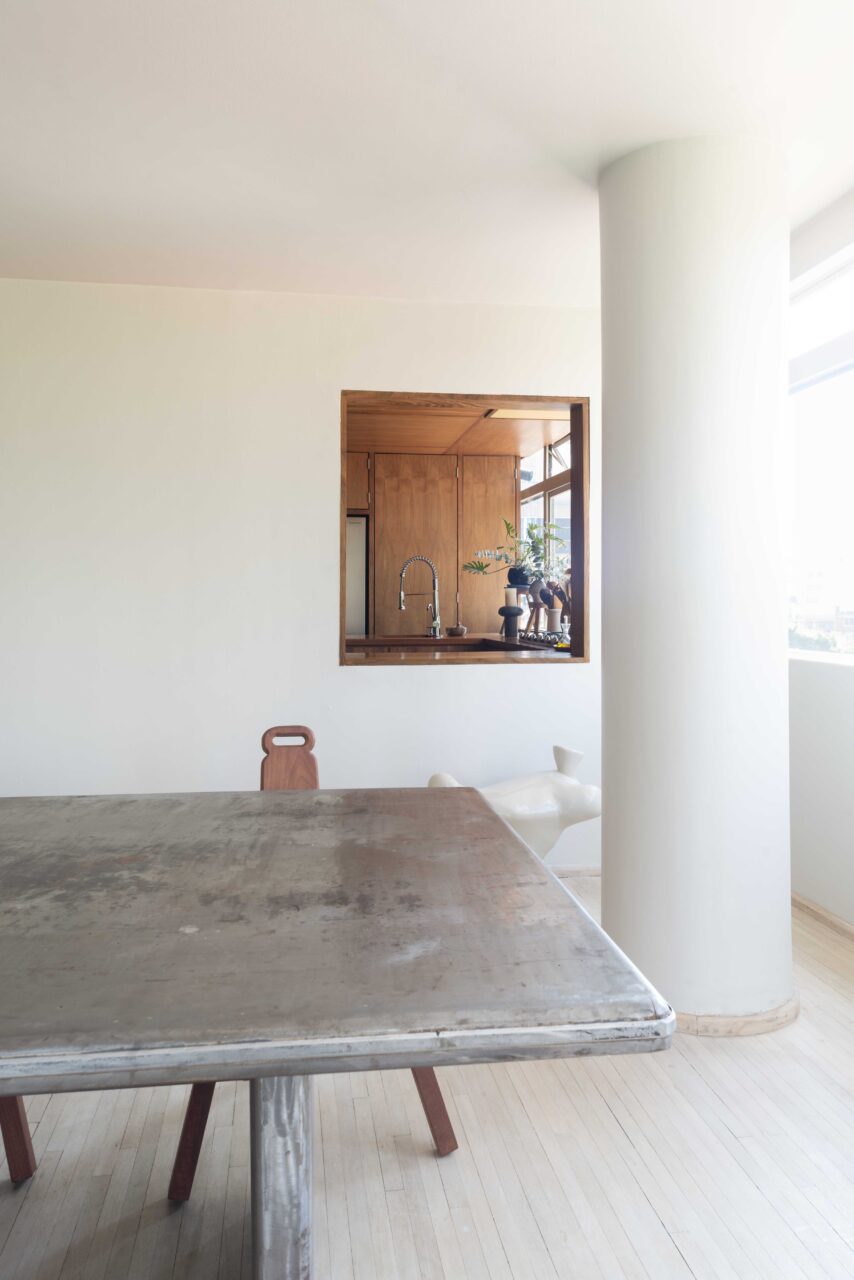 A view of Pol's kitchen through the white living room