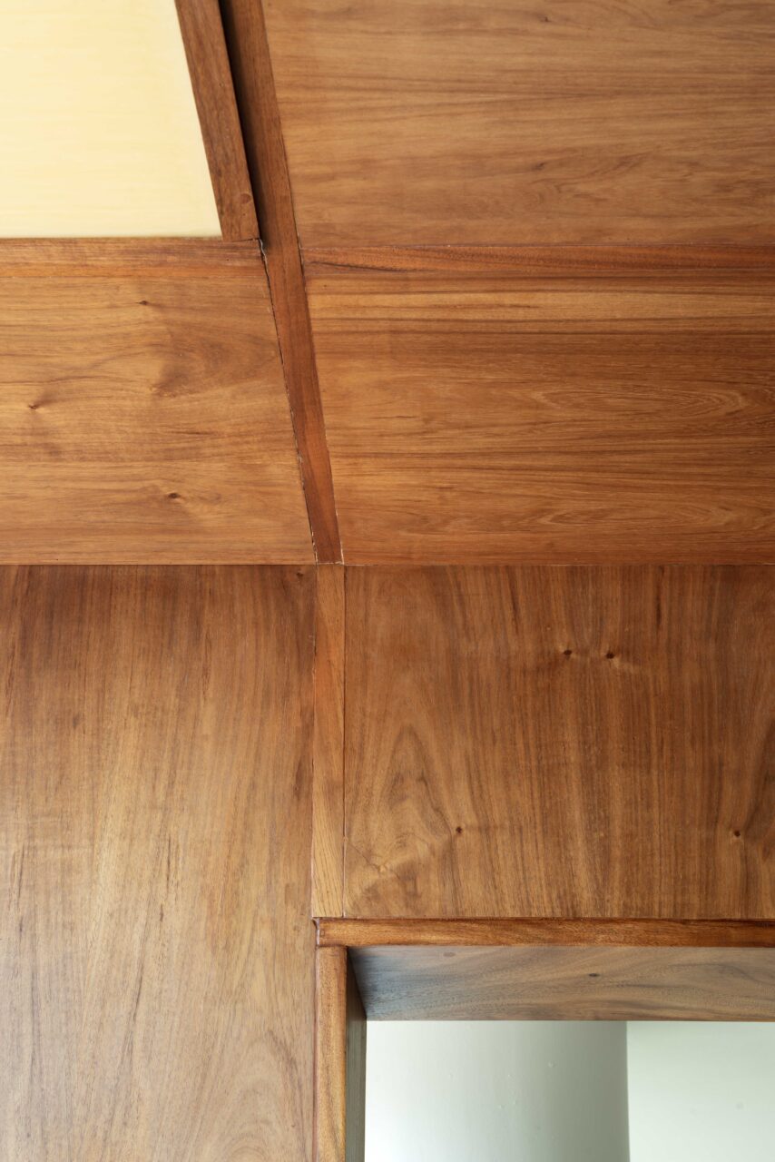 The plywood kitchen from Lanza Atelier continues on the ceiling