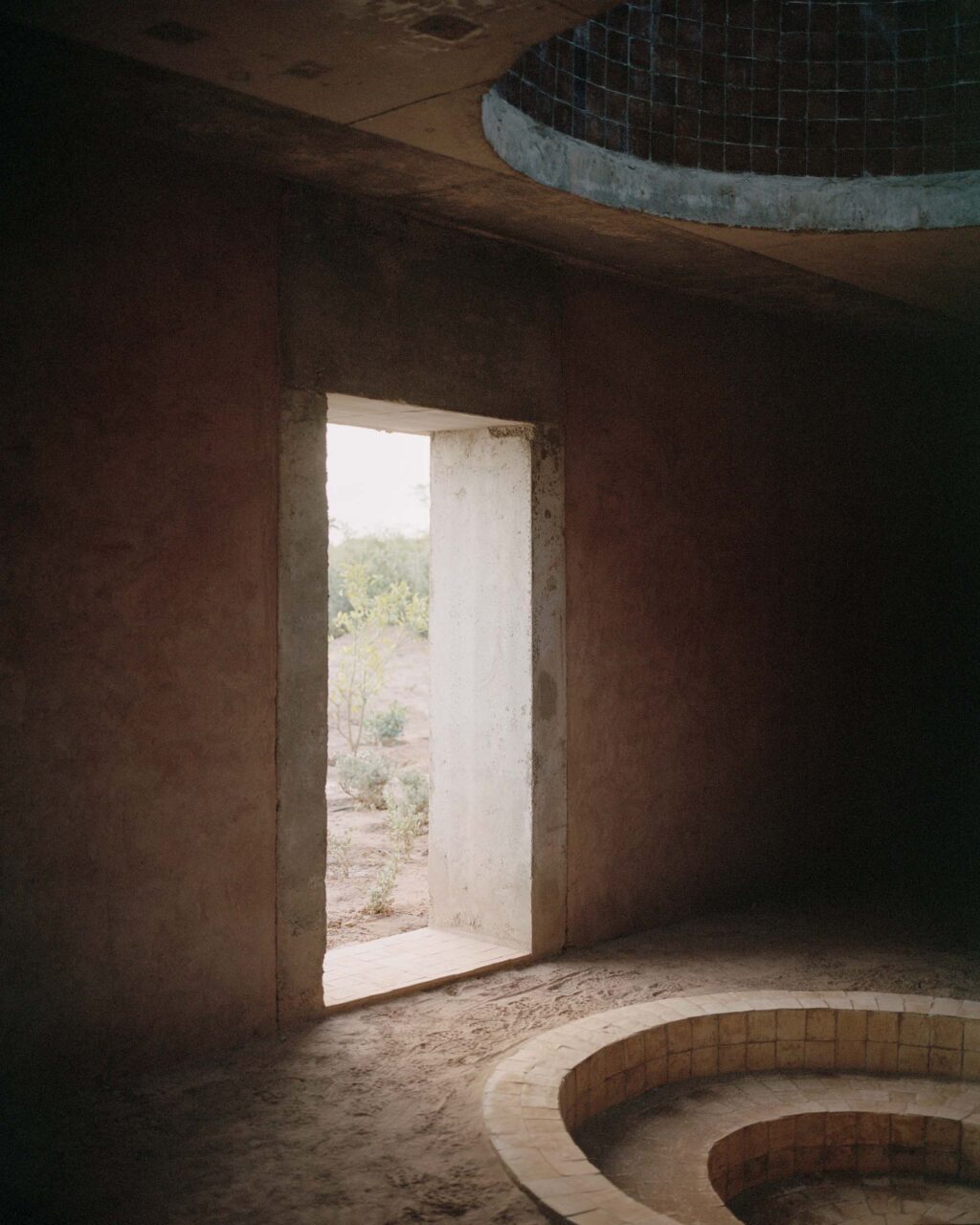 A door leads to a circular nook in the floor of Dar el farina