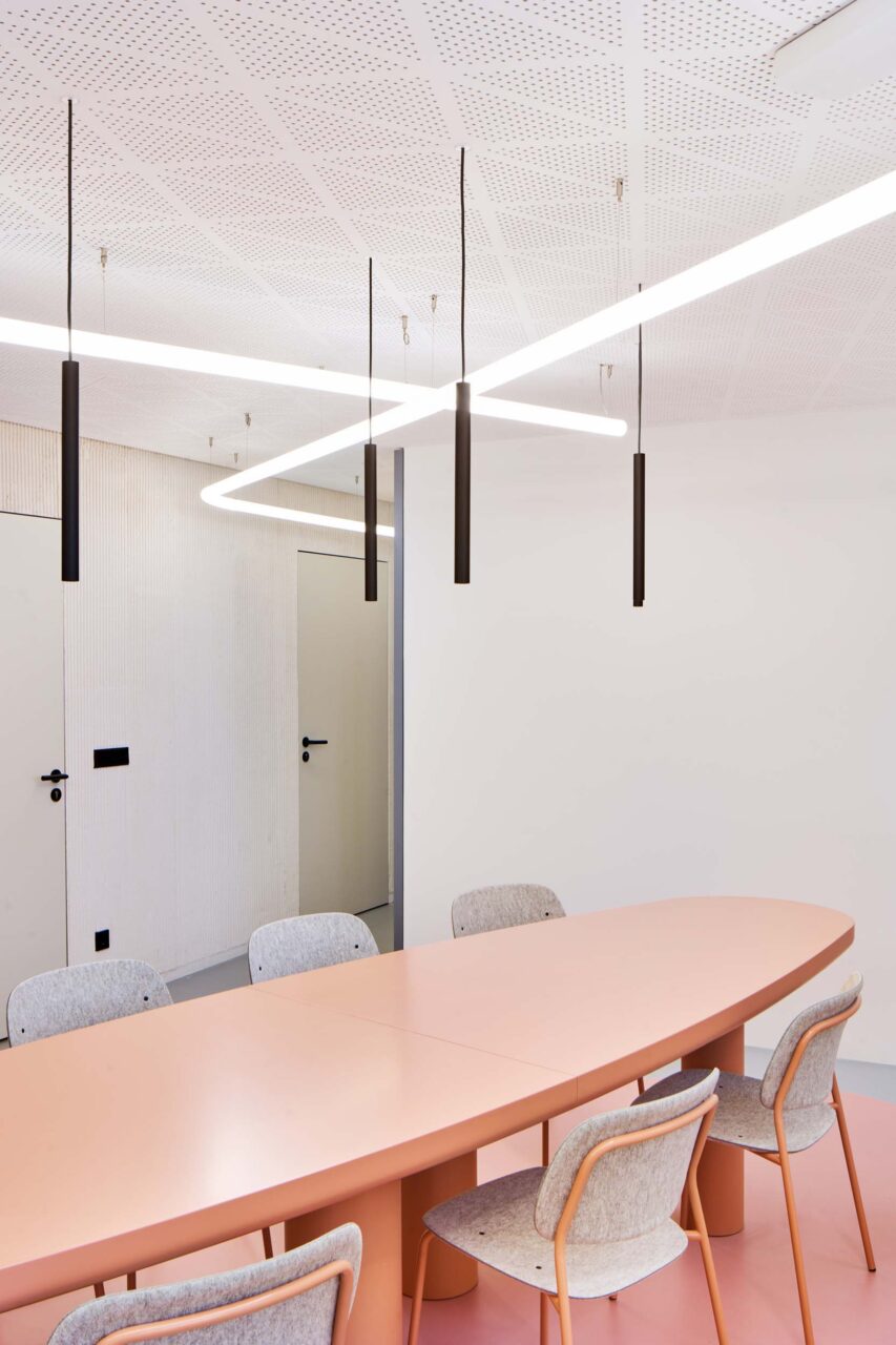The pink communal table at the VDK office