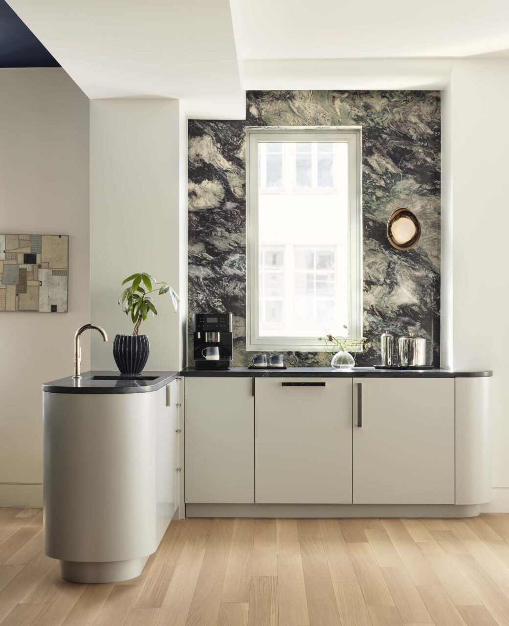 Frederick Tang create a bar area with a marble backsplash