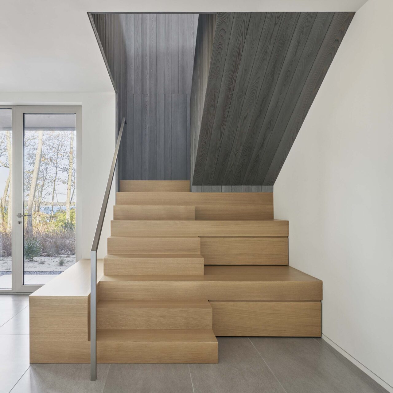 The gray and wooden stairs designed by Desai Chia