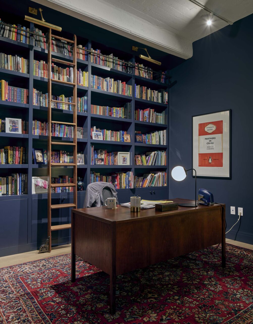 blue shelving in office designed by Sarah Jacoby Architect for a converted loft in DUMBO Brooklyn
