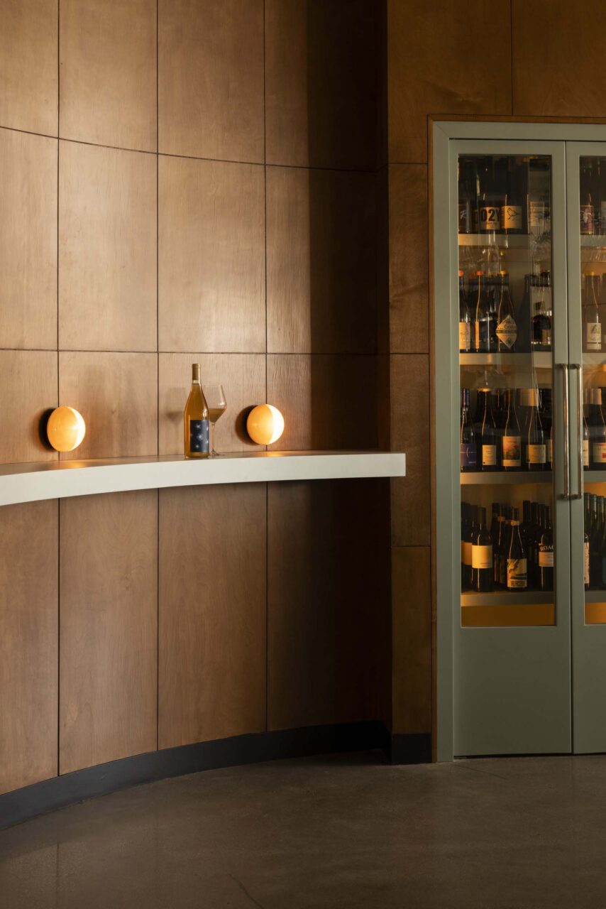Wood paneling and blue accents at bar in LA