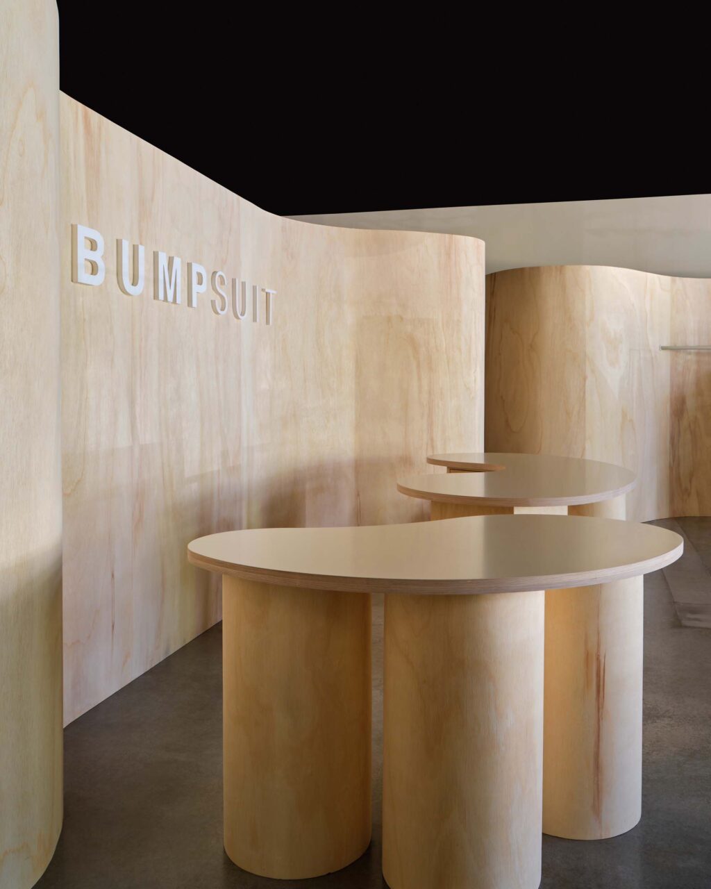 The retail store features curves in plywood