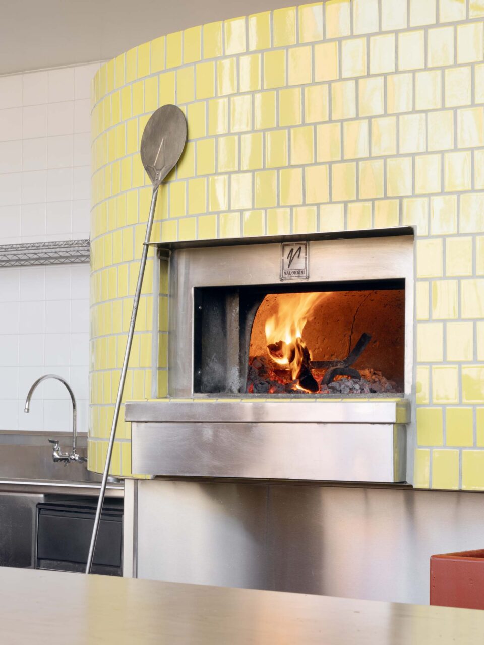 yellow-tiled pizza oven in oakland