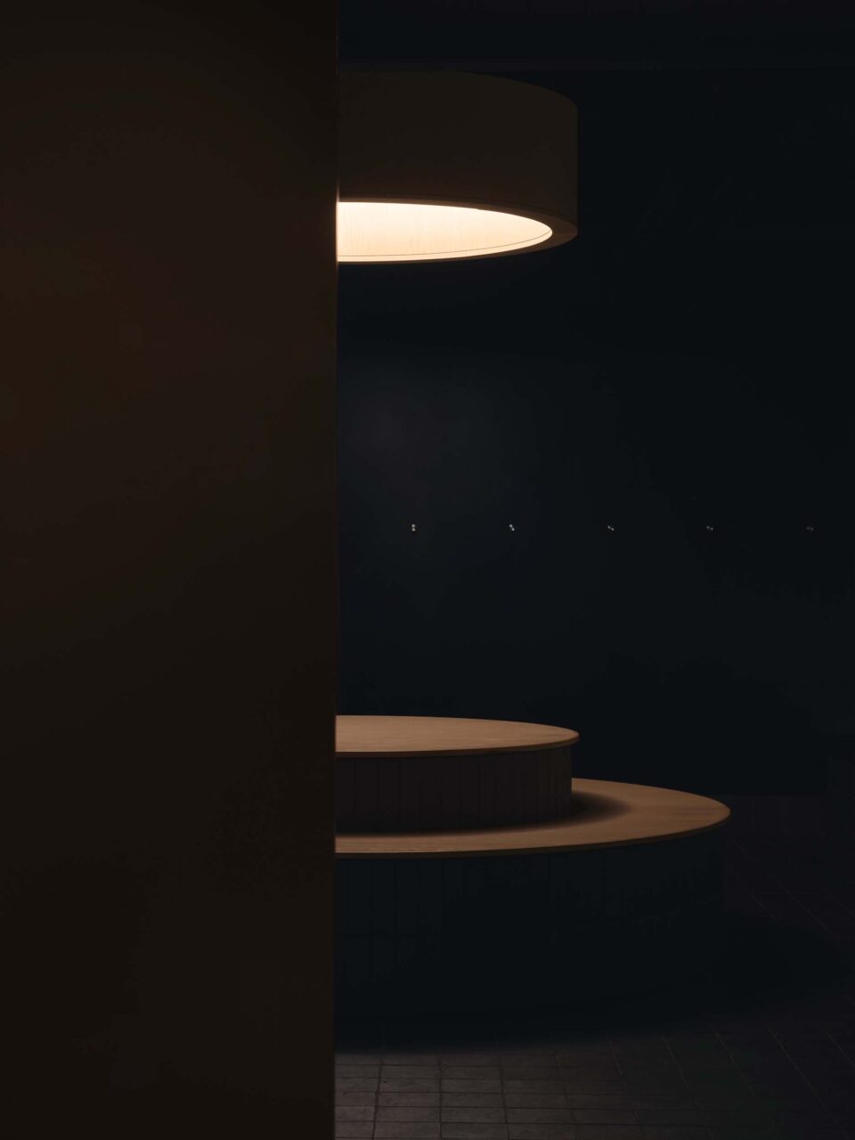 light over circular forms in ice bath room