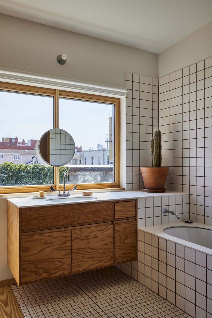 bathroom with white-tiled bathtub