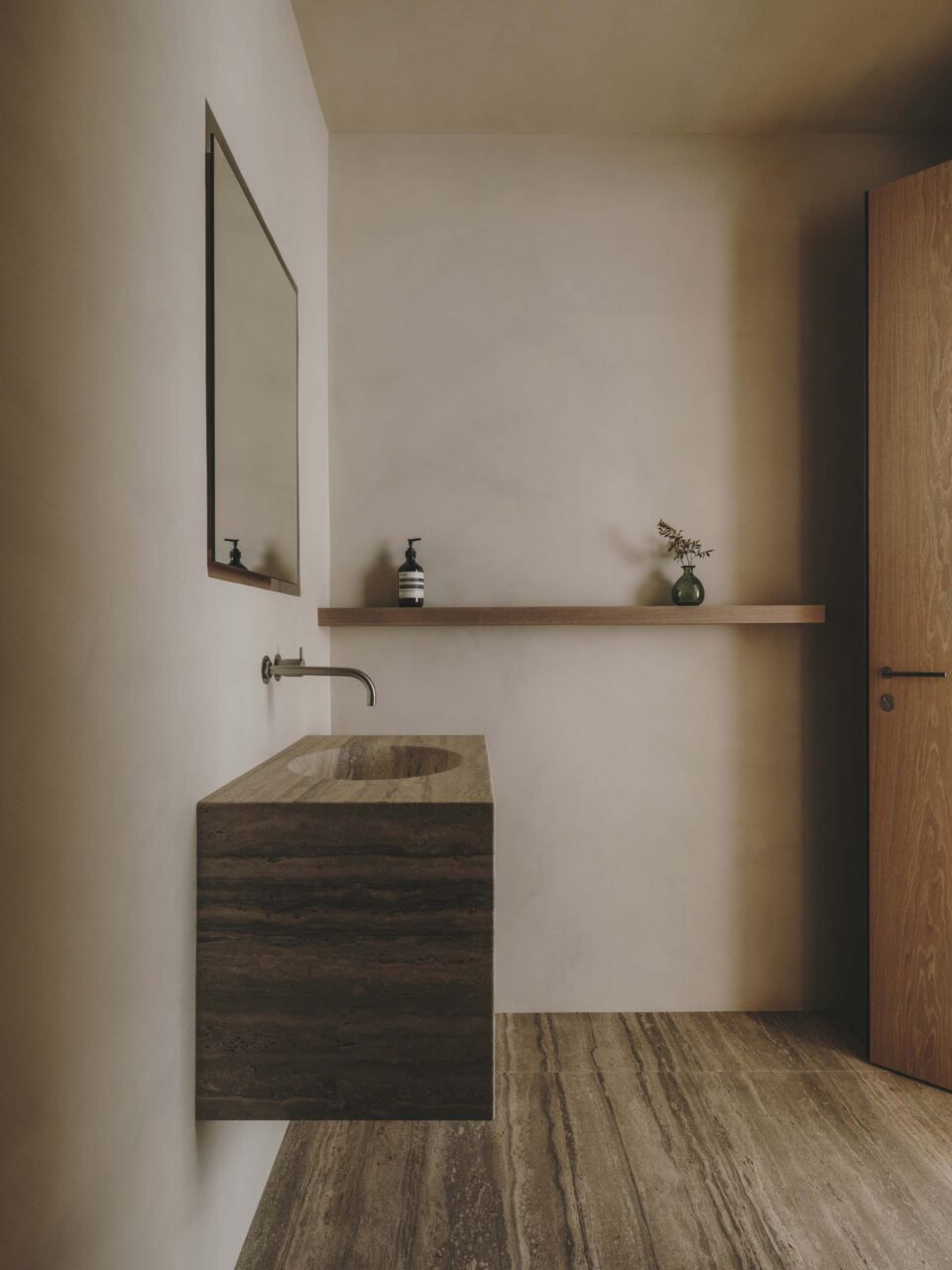 A bathroom with floating sink and vanity