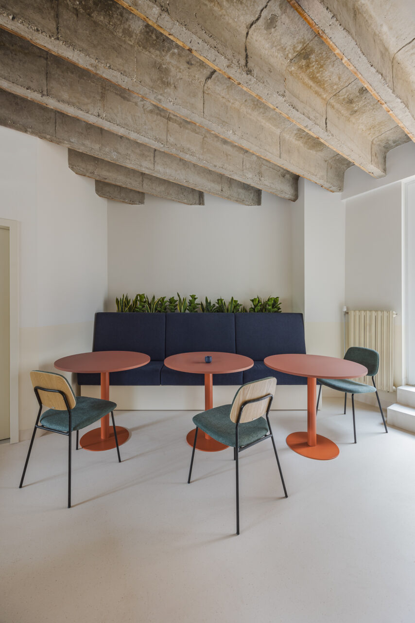 colorful tables and chairs under concrete beams