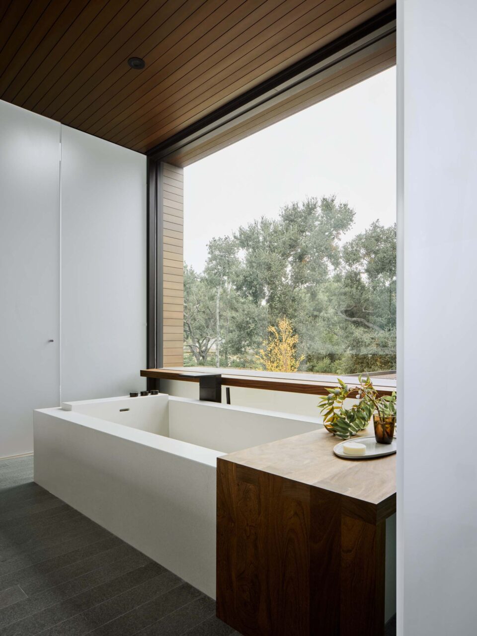 bathroom with large window over tub