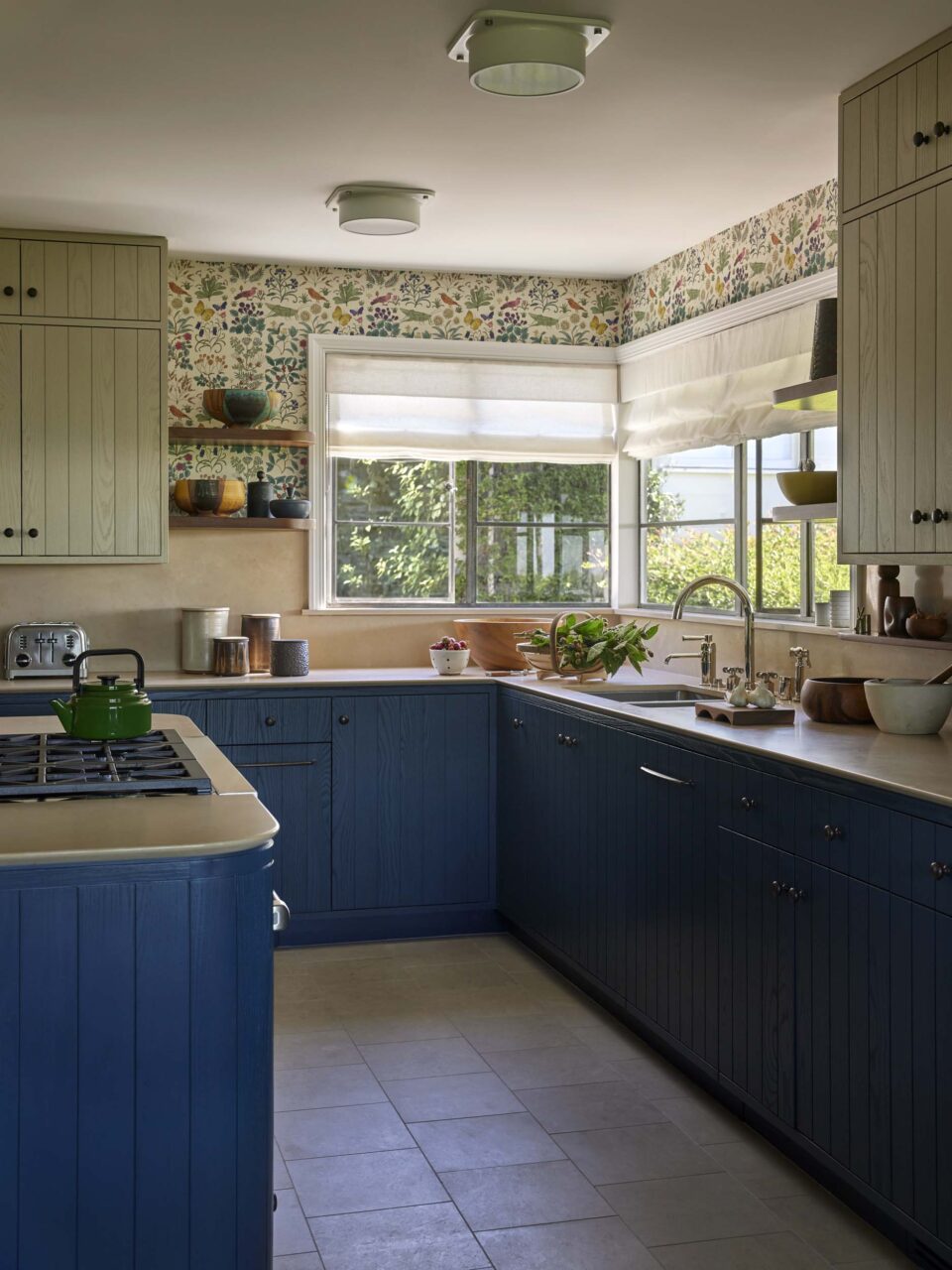 kitchen with blue cabinets and floral wallpaper