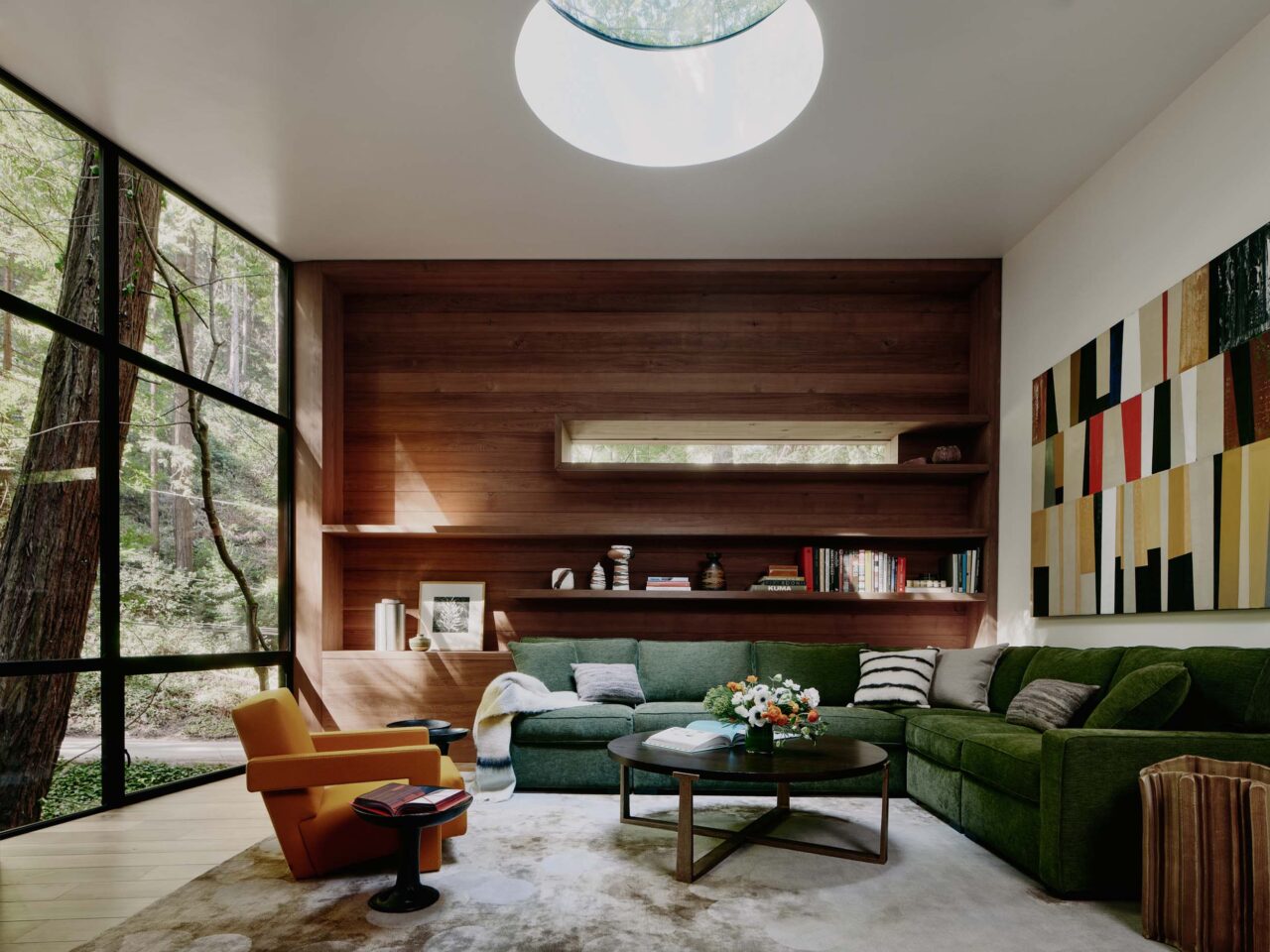 the great room with green sofa and reclaimed wood