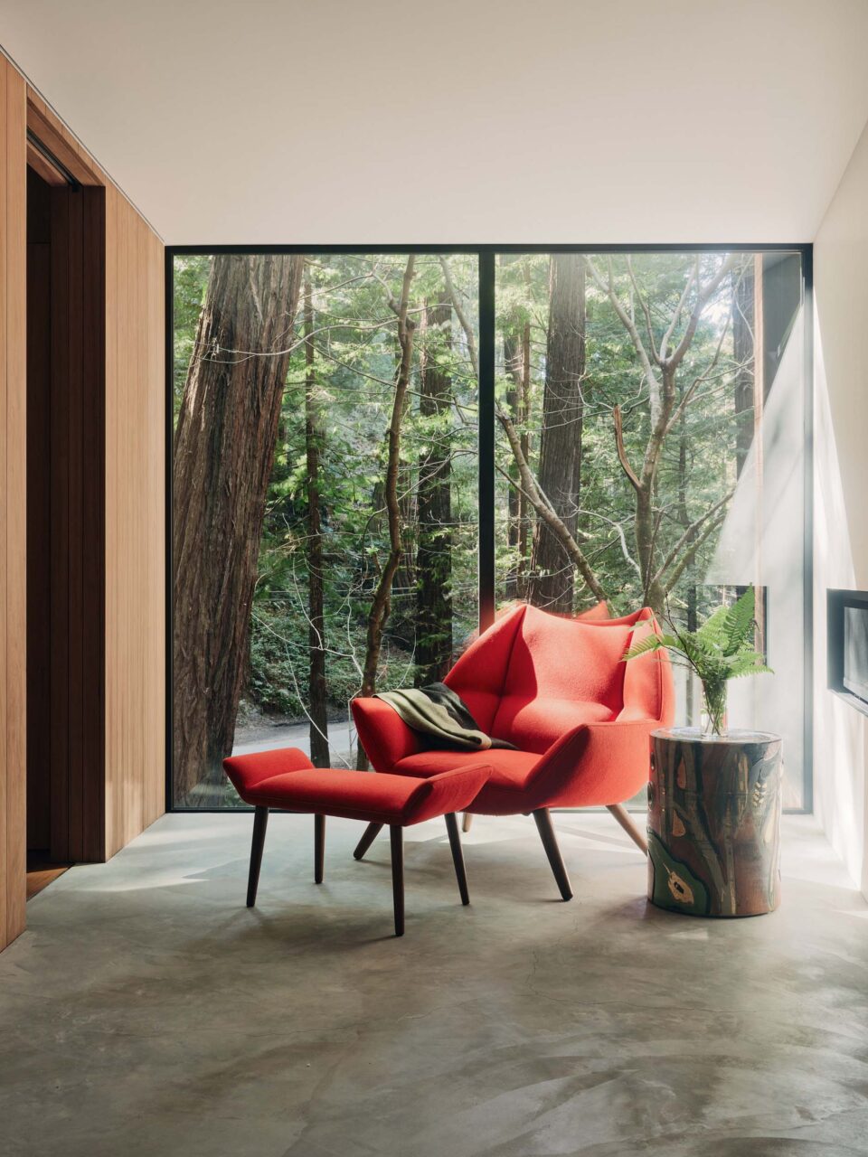 red chair in front of large window