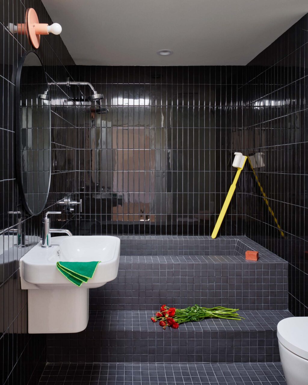 black bathroom with oversized toothbrush
