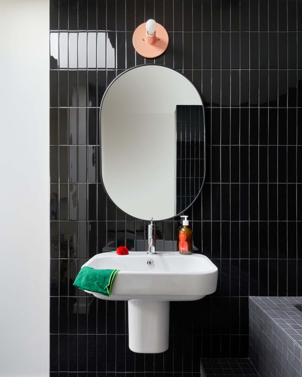 black tiled bathroom with white sink