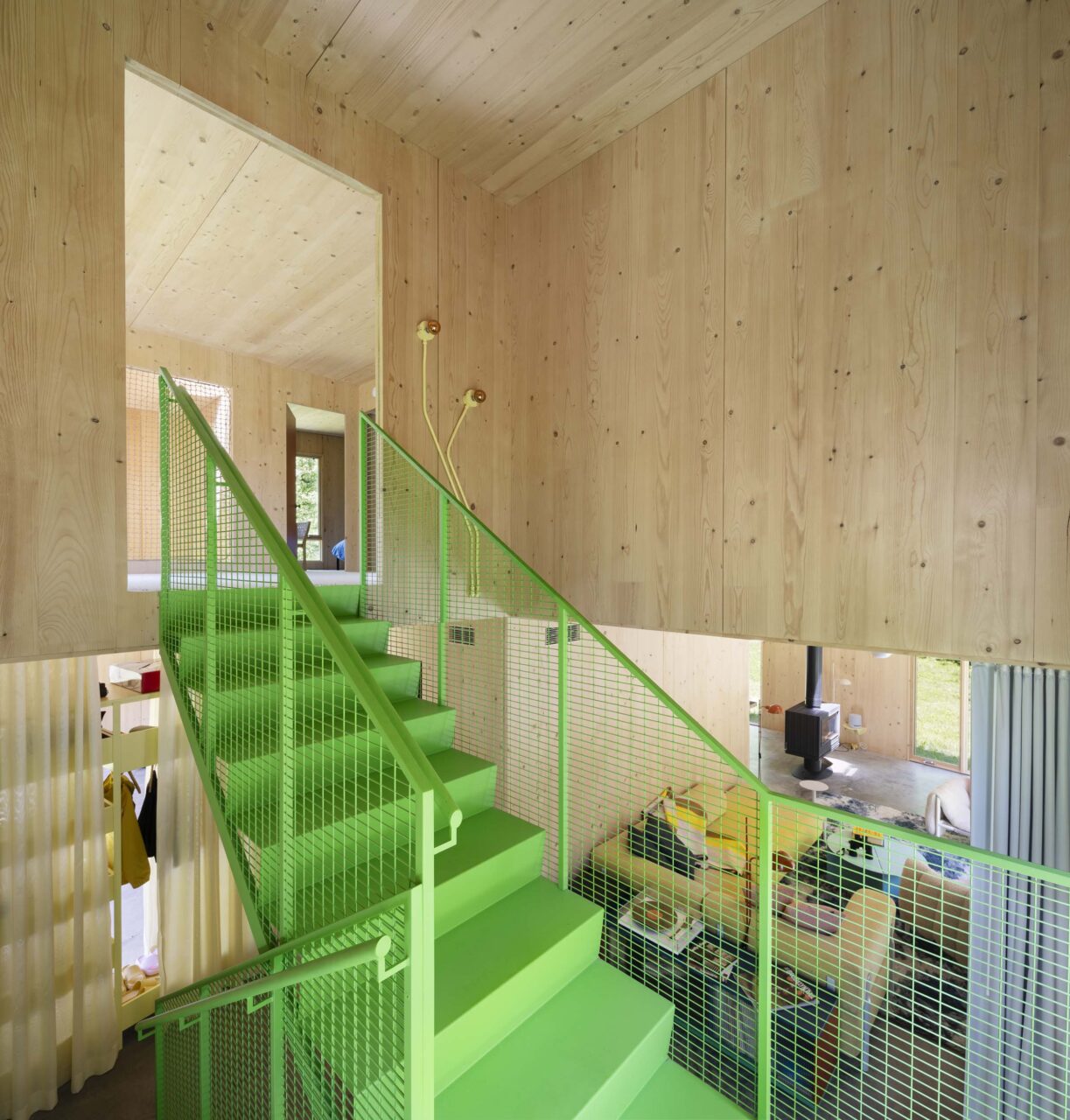 green staircase in double height entry