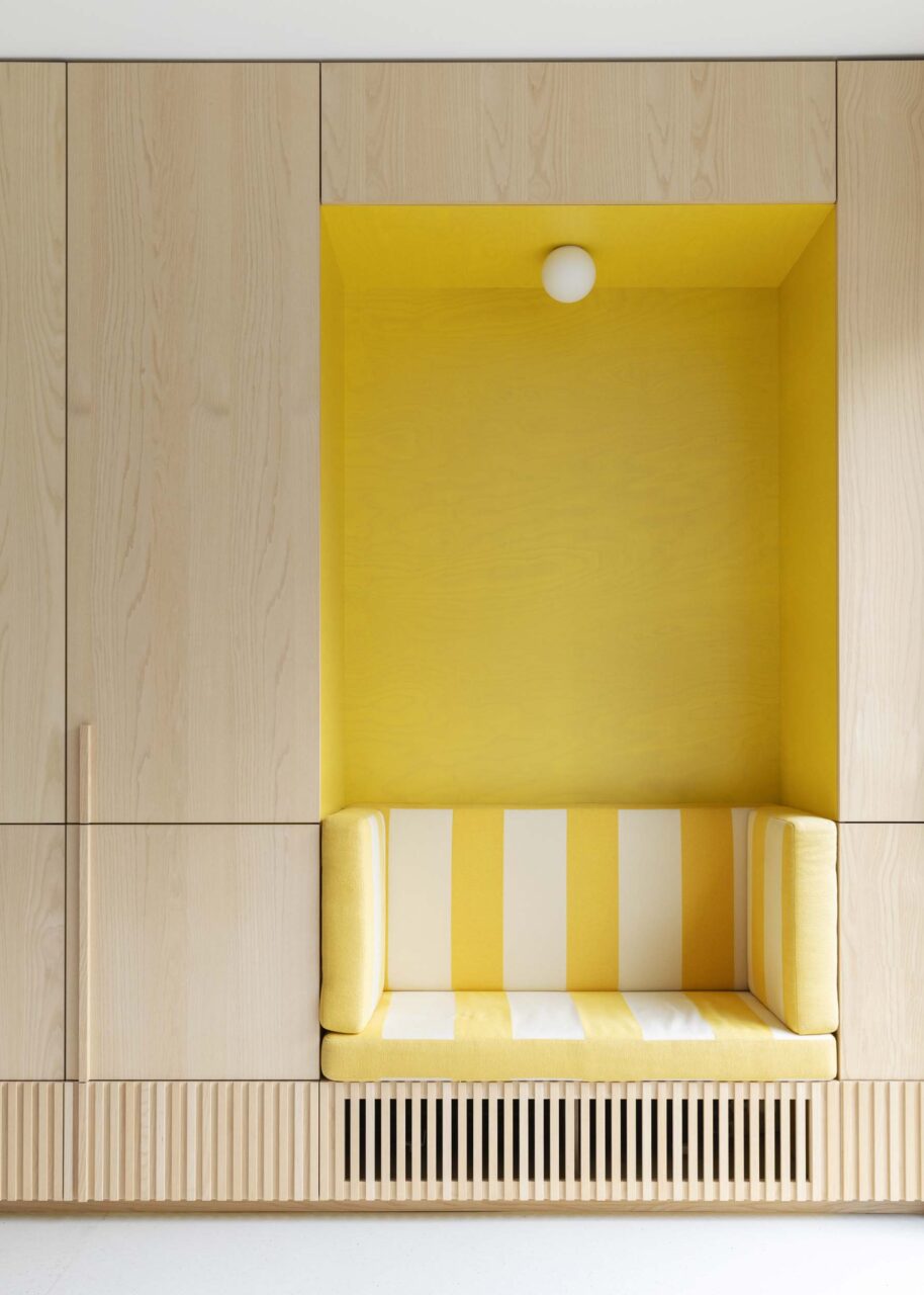 yellow bench in wall of wood