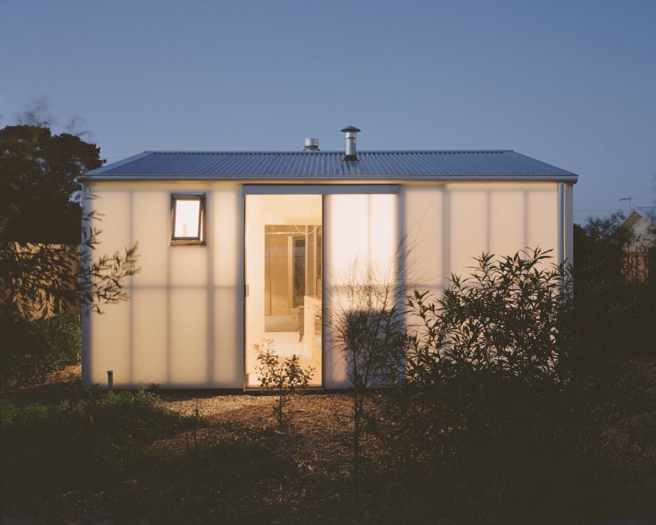 house lit up at night, glowing translucent walls