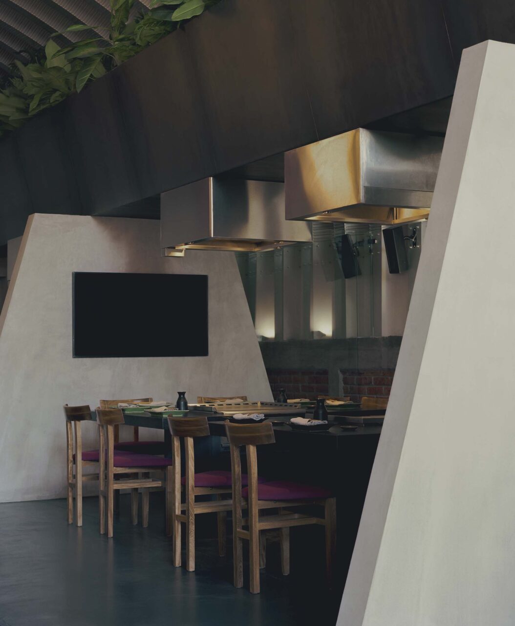 wooden chairs between concrete trapezoids