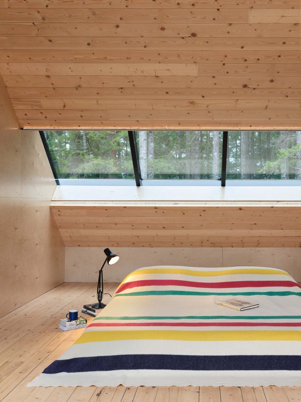 bed on floor over angled wall