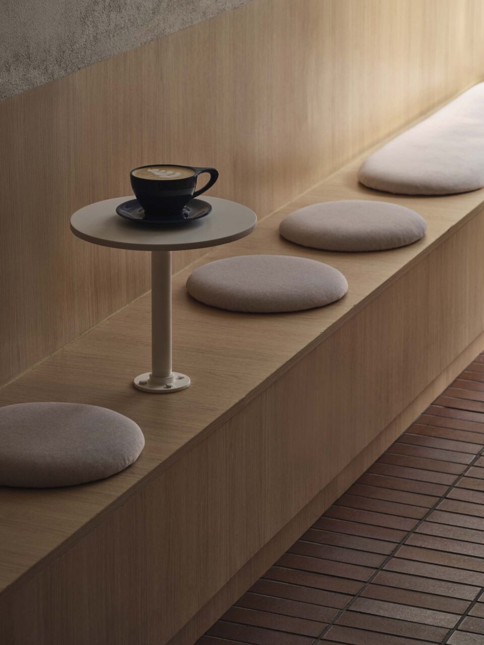 circular cushions on built in bench with tables