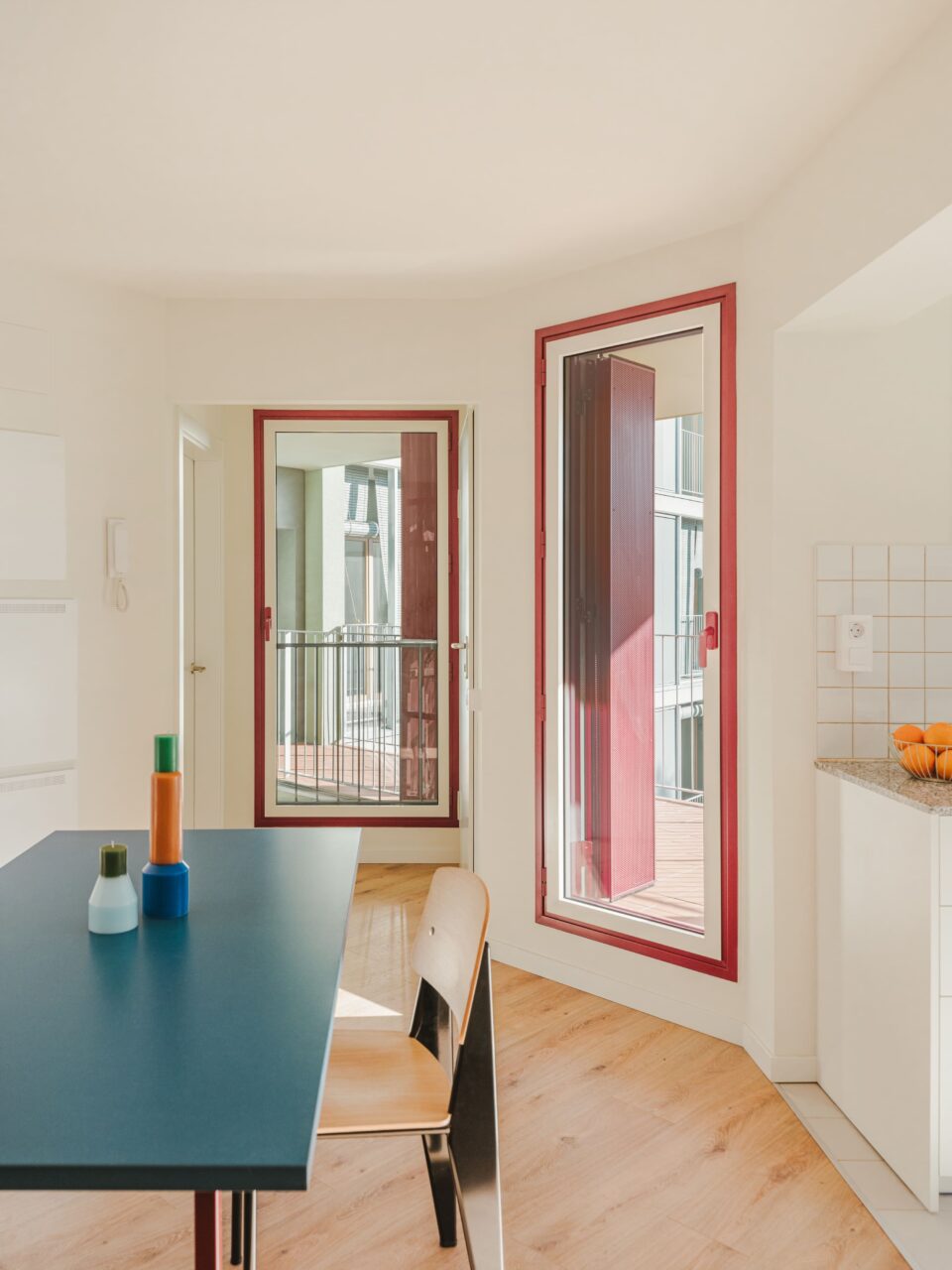 red door frames and blue table in dining room