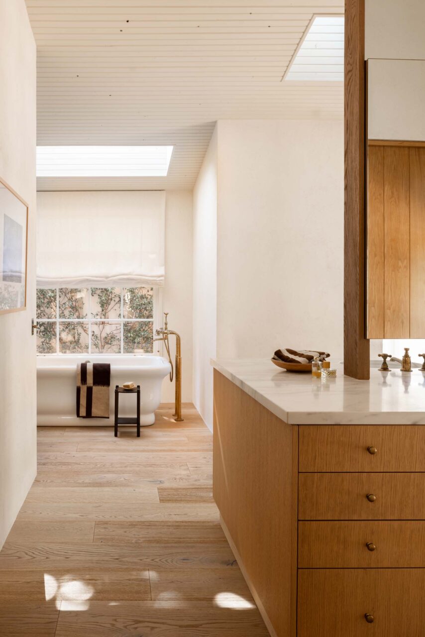 bathroom with skylight and soaking tub