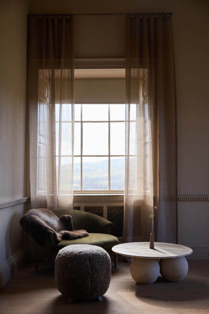 chair next to window with design by box 9
