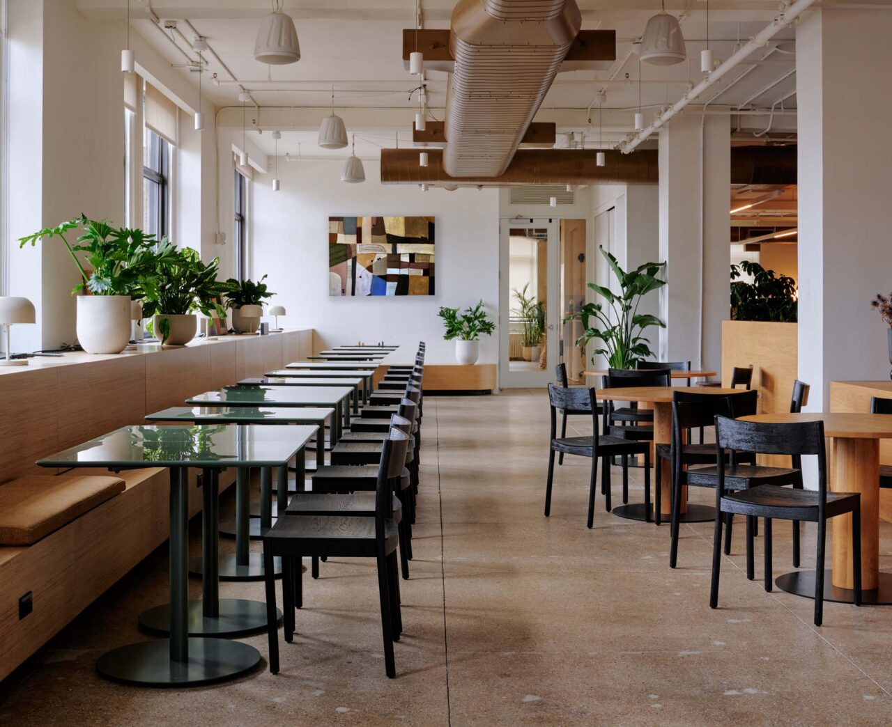 cafe with black wood chairs and reflective tables